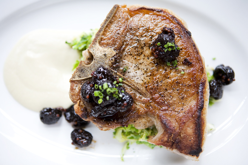 Pork chop with spring onion soubise, brussels, and cherry jam.