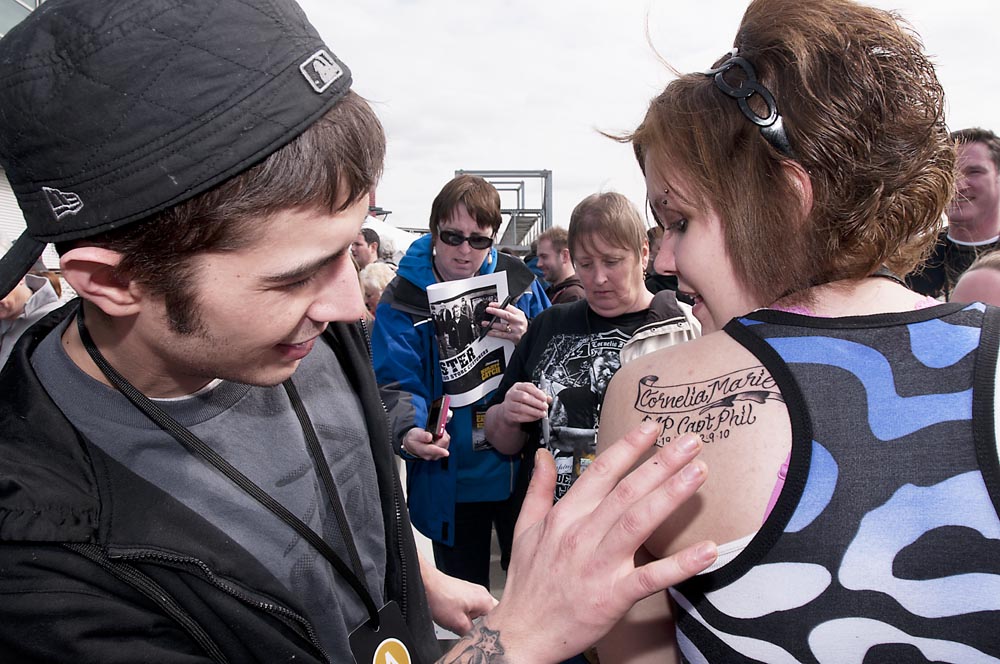 Josh Harris admires the new tattoo Danielle Thomas of Scranton, Penn., has to memorialize his father Capt. Phil Harris of the Cornelia Maria during Deadliest Catch Catchcon at the Bell Harbor Conference Center on Saturday April 9, 2011, in Seattle, Wash.