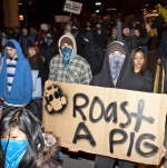 At a Police Brutality Riot protesting Ian Birk escaping charges, participants spit at and threatened Seattle Weekly's photographer, Joe Dyer.