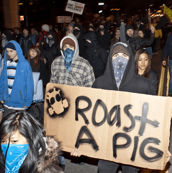 At a Police Brutality Riot protesting Ian Birk escaping charges, participants spit at and threatened Seattle Weekly's photographer, Joe Dyer.