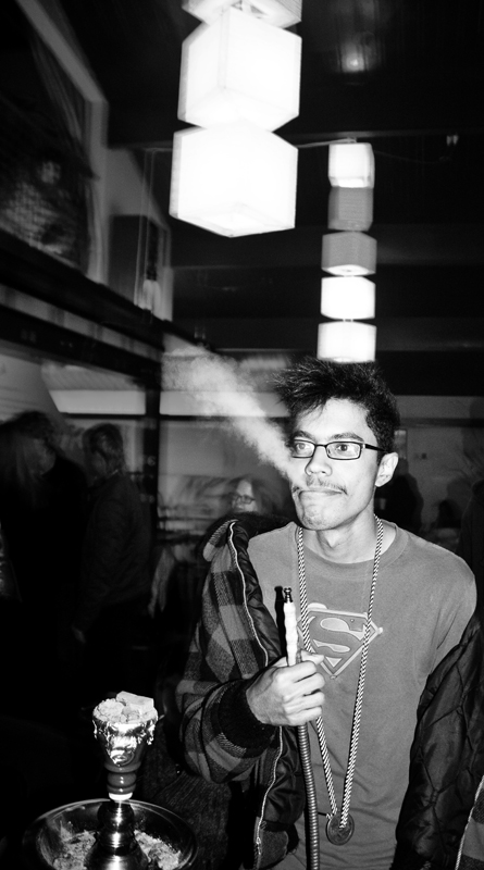 DJ Jimi Jaxon blows smoke before his performance at the Cobra Lounge, a Seattle hookah bar.