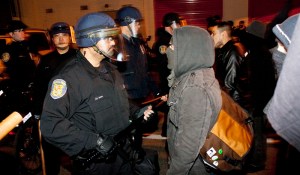 An angry protester faces an officer holding the police line by the Capitol Hill police precinct.The protestor repeatedly hurled insults and challenged the officer to hurt him.