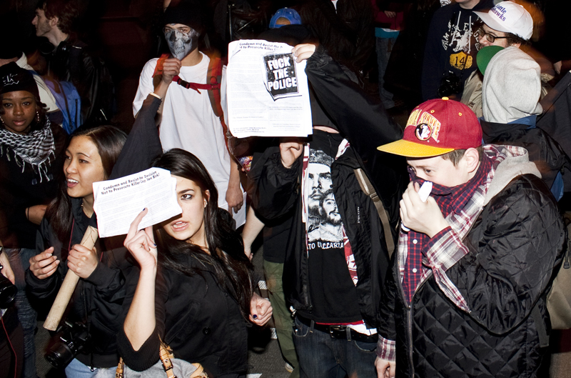 Many protesters distributed papers and held up signs expressing their opinions on the Williams shooting, and on police brutality.