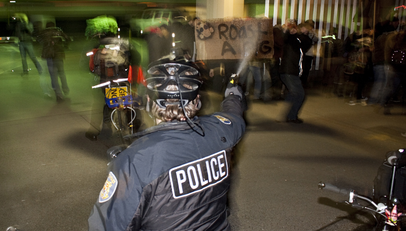 Officers continue to spray to clear the area.