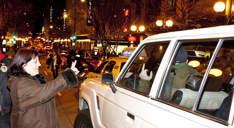 This man in the car clearly despised the protest, giving the finger to protesters as they walked by. A woman countered his gesture with the peace sign.