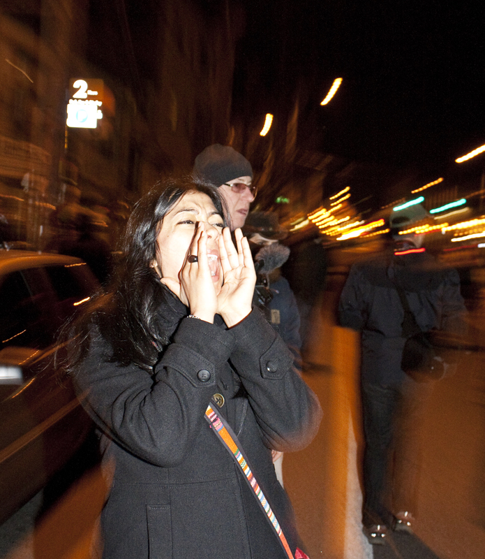 A woman yells at the police line on Capitol Hill near the precinct.