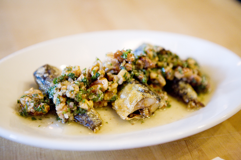 Grilled sardine with walnuts, shallot, and parsley.
