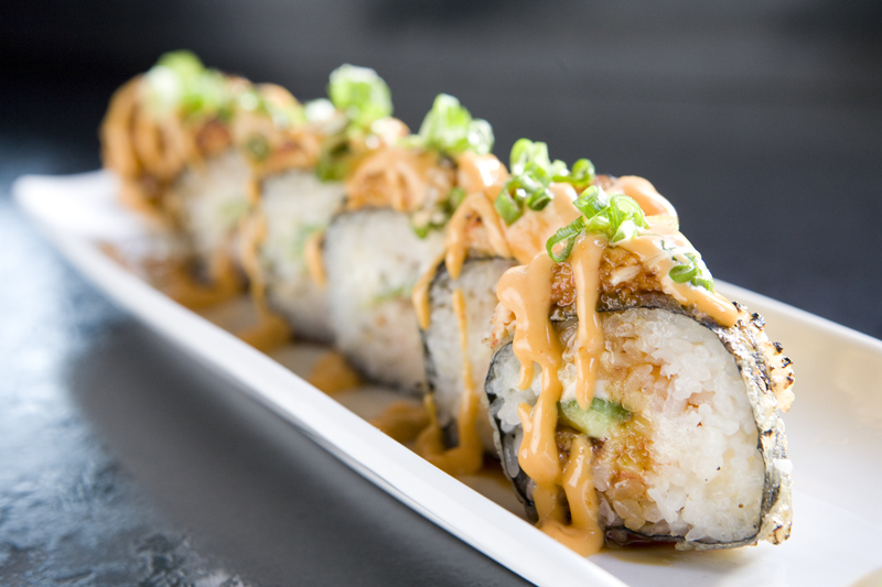 Super Bad Boy: eel, snow crab mix, avocado, cream cheese, tempuraaE™d, toppedwith spicy seared crab, drizzled wth chili aioli, and a soy glaze.