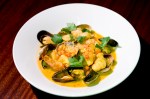 Catalan-style fish soup:Shrimp, clams, mussels & salmon, saffron sofrito broth, almond & breadcrumbs.