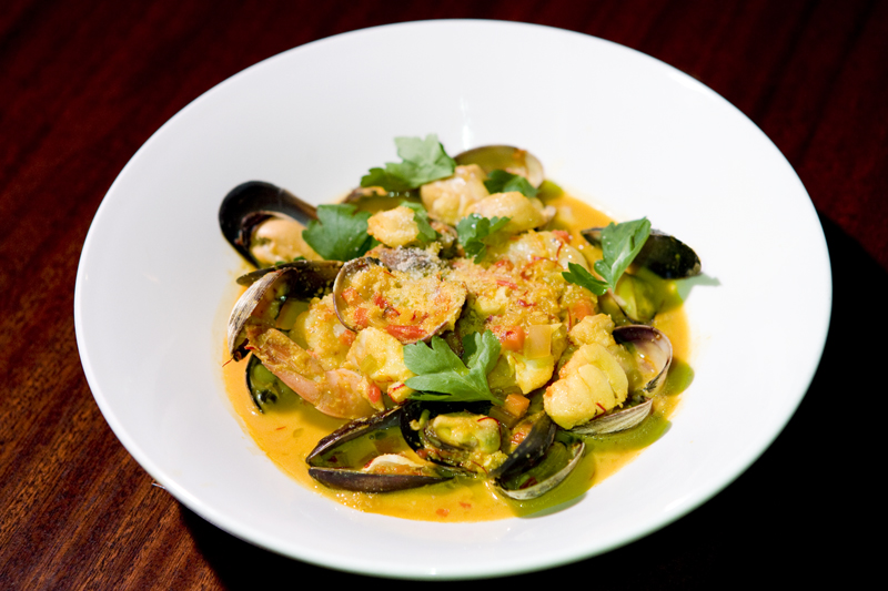Catalan-style fish soup:Shrimp, clams, mussels & salmon, saffron sofrito broth, almond & breadcrumbs.