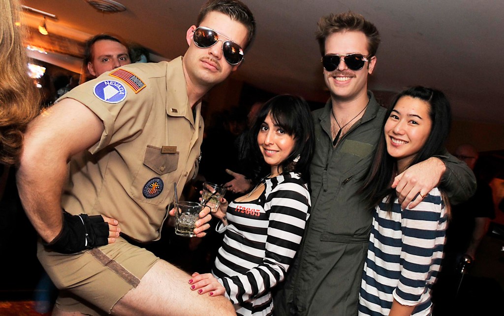 Seattle residents Eric Schalla, left, Christina Posner, Alex Salkin, and Patty Liu strike a pose during the 2010 Movember Seattle Gala Parte at Trinity on Saturday evening Nov. 27, 2010, in downtown Seattle. Schalla played Lt. Dangle and Posner played his prisoner. Salkin was Goose from Top Gun and Salkin also played a prisoner. Movember is a charity event that originated in Australia in 2003 and is growing exponentially throughout the world. As part of the fundraising challenge, men grow a mustache beginning November 1st to help raise funds for prostate and testicular cancer research. The funds go to the Livestrong Foundation and also for prostate cancer research.