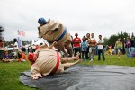 Barby McShain gets airborne as he wrestles his brother Dugan at the Family 4th Picnic at Gasworks Park in Seattle, Wash., on Sunday, July 4, 2010.  (Photo by Matthew Williams for The Seattle Weekly)
