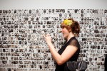 Kristen Blush takes a picture of her friend next to the wall of photos at one of the photo booths scattered throughout the Seattle Art Museum during the SAM Remix in Seattle, Wash., on Friday, June 4, 2010.  The event included the "Pop Culture Fashion" runway show, music with DJ Riz, and many more activities and performances.  (Photo by Matthew Williams for The Seattle Weekly)