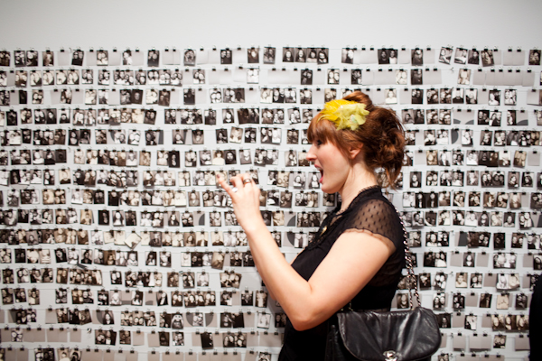 Kristen Blush takes a picture of her friend next to the wall of photos at one of the photo booths scattered throughout the Seattle Art Museum during the SAM Remix in Seattle, Wash., on Friday, June 4, 2010.  The event included the "Pop Culture Fashion" runway show, music with DJ Riz, and many more activities and performances.  (Photo by Matthew Williams for The Seattle Weekly)