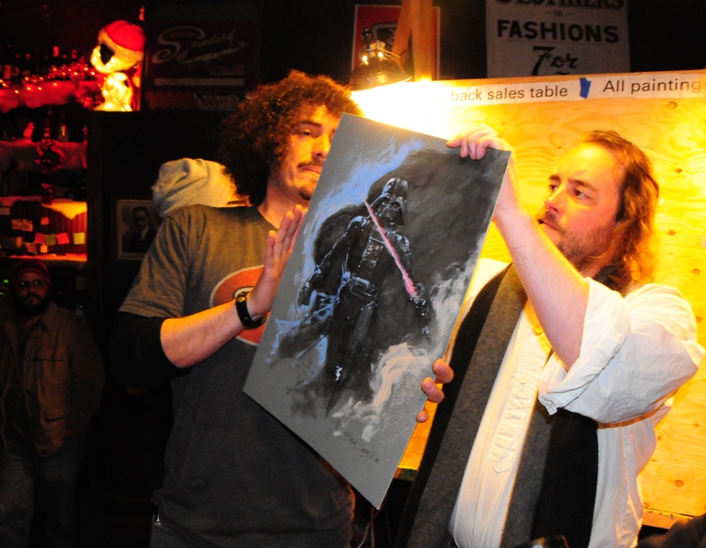 And with the help of event organizer Augie Pagan, Brian signs and prices his artwork.