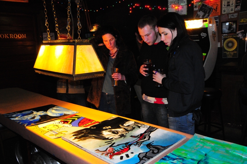 Considering the paintings for purchase.