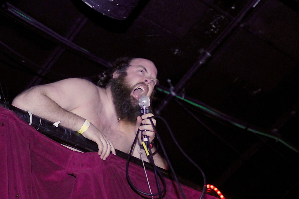 Les Savy Fav frontman Tim Harrington screams from the top of a wall while permorming at Neumos on Capitol Hill on Saturday Evening Dec. 5, 2010, in Seattle.
