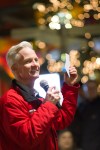 Curley also explains to the guests how to use the Holiday Celebration Shopping Passport, a discount coupon for surrounding shops and restaurants. All proceeds from the event will be donated to the Seattle Humane Society.