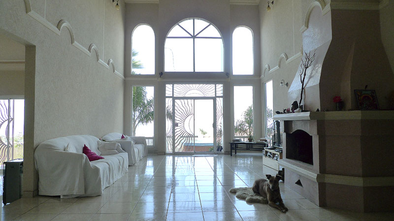 The living room, with the veranda ahead through the sliding glass door.