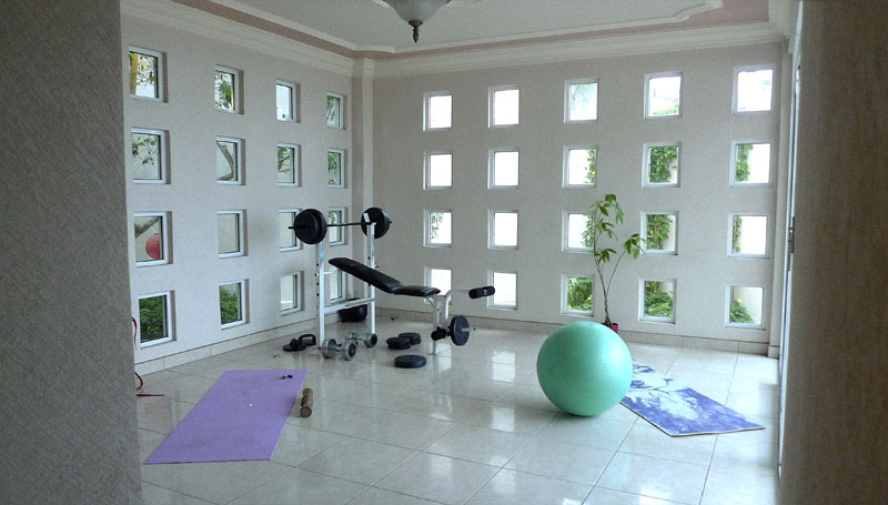 A small weight room doubles as a yoga space.
