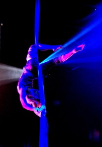 Cabiri doing aerial performance above dance floor.