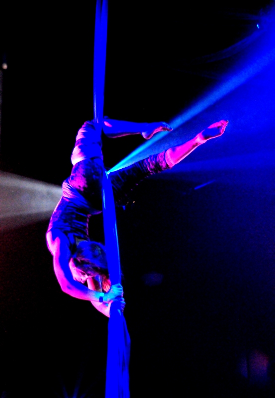 Cabiri doing aerial performance above dance floor.