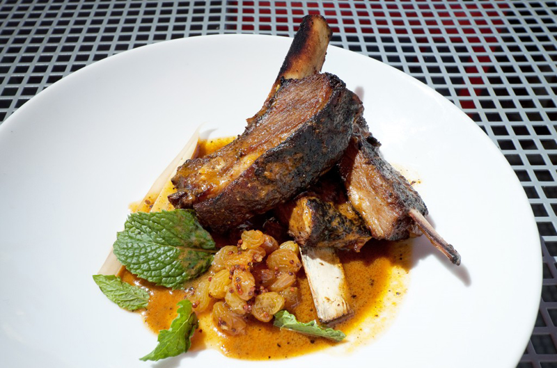 Curried lamb ribs with pickled green papaya and currant chutney.