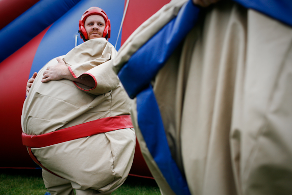 Dugan McShain, left, sizes up his brother Darby as they are suited up to wrestle at the Family 4th Picnic at Gasworks Park in Seattle, Wash., on Sunday, July 4, 2010.  (Photo by Matthew Williams for The Seattle Weekly)