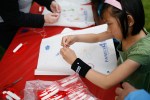Children and adults make kites at Gasworks Park during the Family 4th Picnic in Seattle, Wash., on Sunday, July 4, 2010. (Photo by Matthew Williams for The Seattle Weekly)