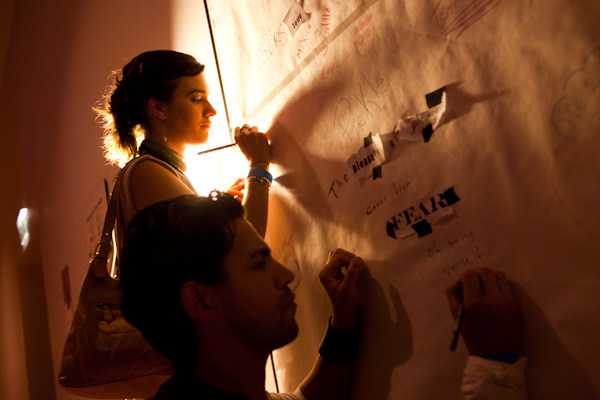 Alexis Vergalla writes on the wall for "In a Word", part of the Andy Warhol Exhibition at the SAM Remix in Seattle, Wash., on Friday, June 4, 2010.  The event included the "Pop Culture Fashion" runway show, music with DJ Riz, and many more activities and performances.  (Photo by Matthew Williams for The Seattle Weekly)