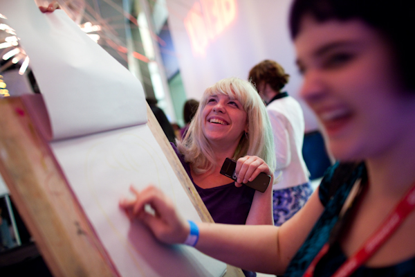 Meriah Dainard has her portrait drawn by her friend Molly Gillette during the SAM Remix in Seattle, Wash., on Friday, June 4, 2010.  The event included the "Pop Culture Fashion" runway show, music with DJ Riz, and many more activities and performances.  (Photo by Matthew Williams for The Seattle Weekly)