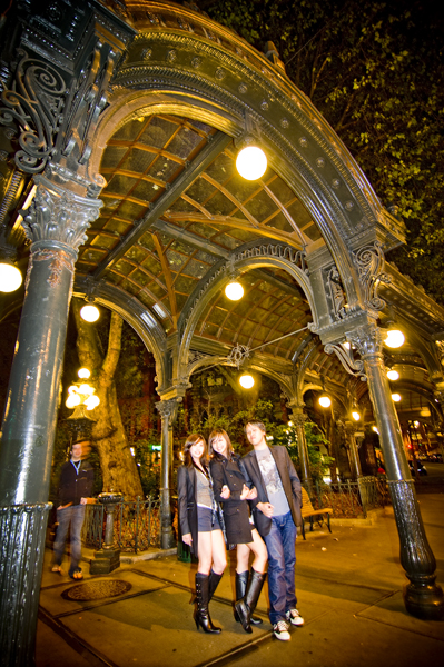 Partiers pose under the landmark glass and cast wrought iron pergola - originally built in 1909. In 2001, an 18-wheeler hit and demolished the pergola, which was then rebuilt.