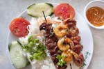 Rice plate with grilled pork, shrimp and pork meatballs.