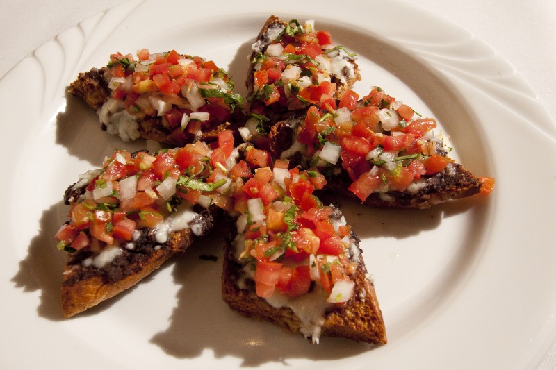 Molletes (vegetarian). Toasted bread with beans, queso, and pico de gallo.