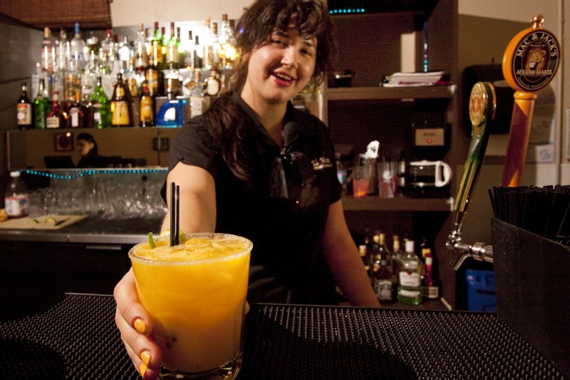 Cute barmaid serving a JalapeA±o Margarita. Note the yellow fingernails!