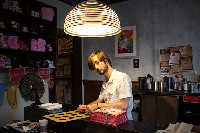 When it gets slow at Cupcake Royale, Jordan folds boxes.