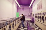 Toni prefers the Madrona Laundromat to others in the area because it's always clean and the people are nice. I like it because it's purple and has a checkered floor.