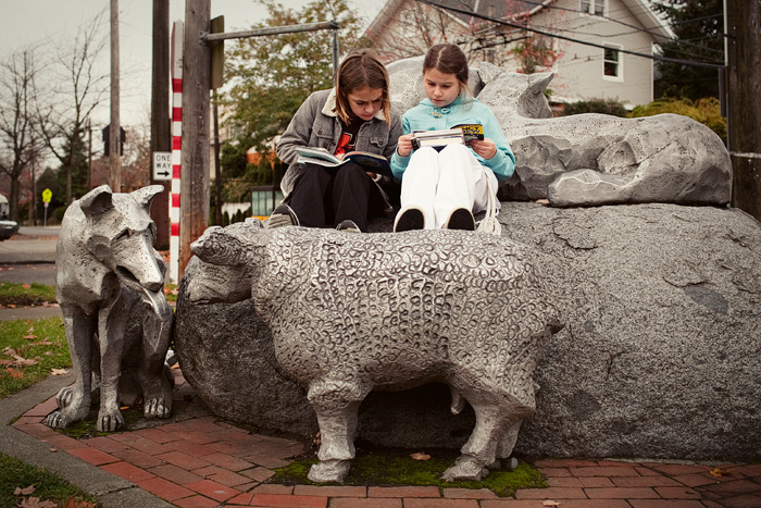 Gaya & Asiyah read their library books outside the Madrona - Sally Goldmark branch.