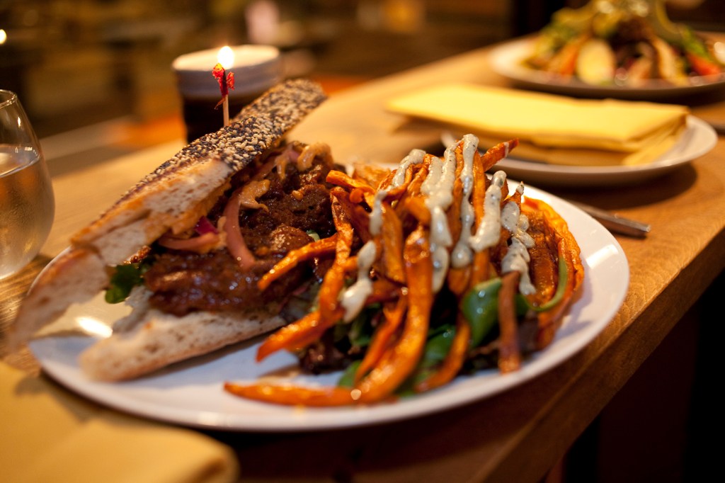 While the Hillside version needs to be eaten over the sink, lest you look like a random victim on Dexter, at Plum, the sandwich never spills out. Plus itaE™s garnished with a mass of sweet-potato fries covered in soy-mayonnaise scribbling.