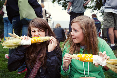 Kalee and Meghan devour some corn while waiting for Viva Voce.