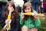 Kalee and Meghan enjoy their corn while waiting for Viva Voce to come on.