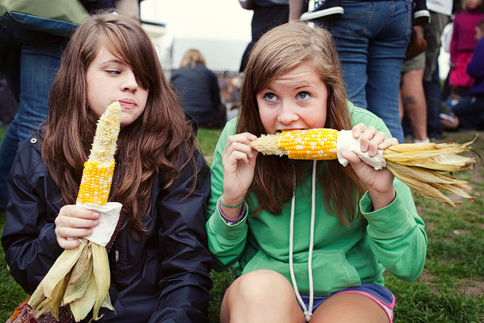 Kalee and Meghan enjoy their corn while waiting for Viva Voce to come on.
