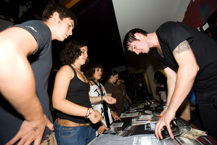 The Whoremoans sign autographs.