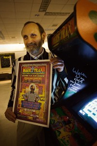 Watler Day, founder of Twin Galaxies and referee to video game record breakers in front of Make Trax, which he holds the scoring record for.