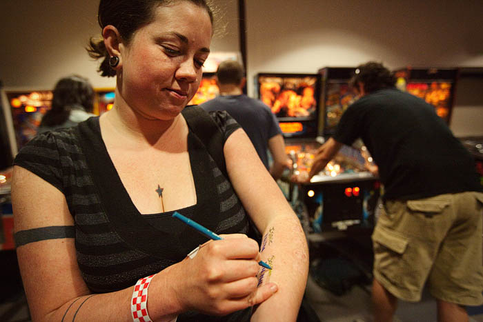 Sarah has been keeping a score tally of wins on her arm.A  Isaac is ahead, but not by much.