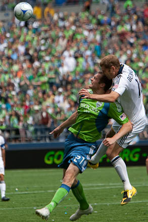 Gregg Berhalter pulls down Nate Jaqua as they both go up for a header.