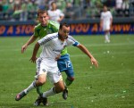 Galaxy star Landon Donovan and Sounder Nathan Sturgis tangle in the first half.