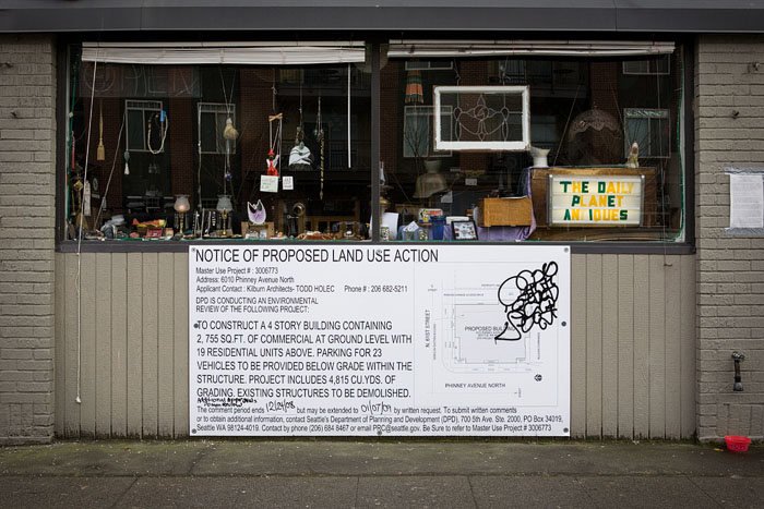 Some locals are up in arms over a proposal to demolish the building at 61st & Phinney, and replaces it with a four-story, mixed-use building. The current structure houses Rooster's, Chef Liao, Daily Planet Antiques, and Phinney Ridge Cleaners.