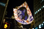 Derick Thurman, an 18-year-old from Chicago and first-time voter, holds up a poster that he bought for five dollars.