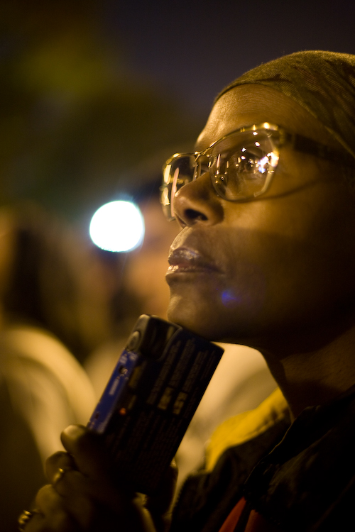 A woman in the trees records Obama's acceptance speech